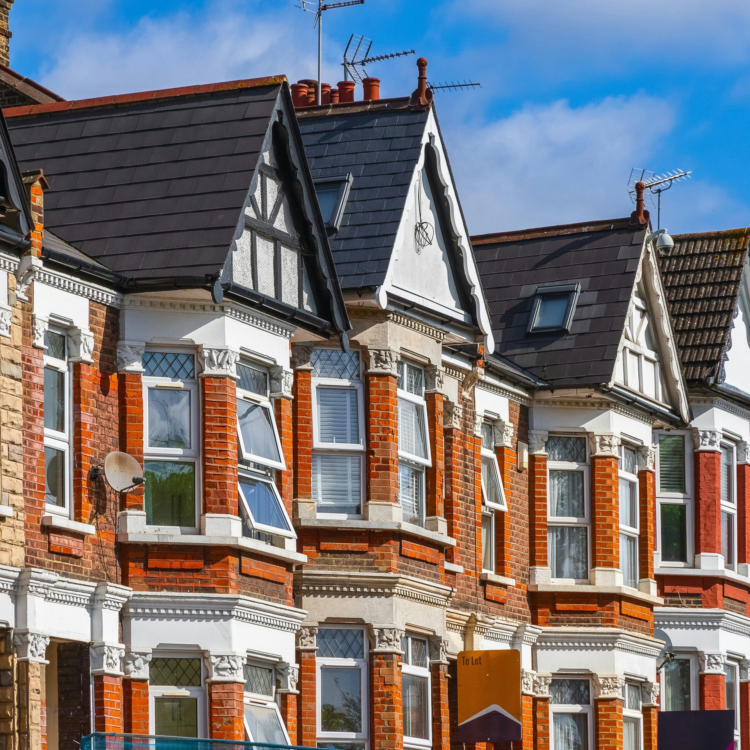 Photo of Victorian era Terrace houses with orange brickwork and slate roofing